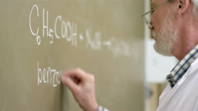 stock-footage-close-up-of-a-university-professor-writing-chemistry-equations-on-the-blackboard-during-a-lecture